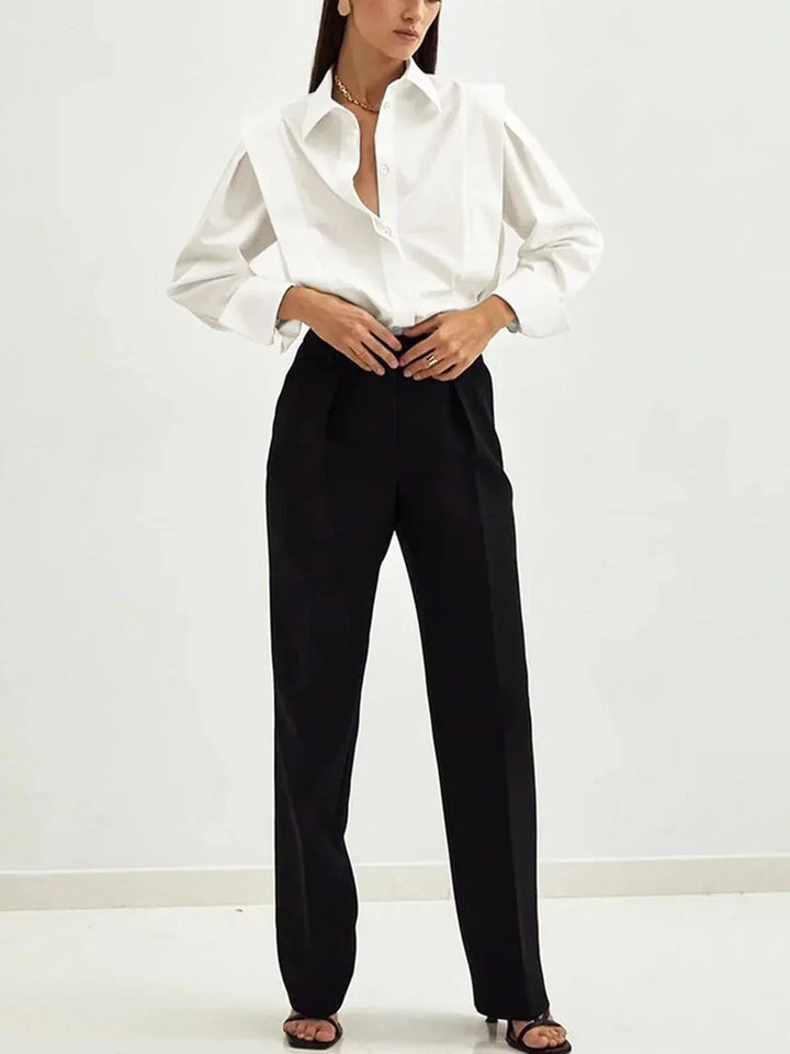 Women's white button-up shirt with long sleeves and buttoned cuffs detail