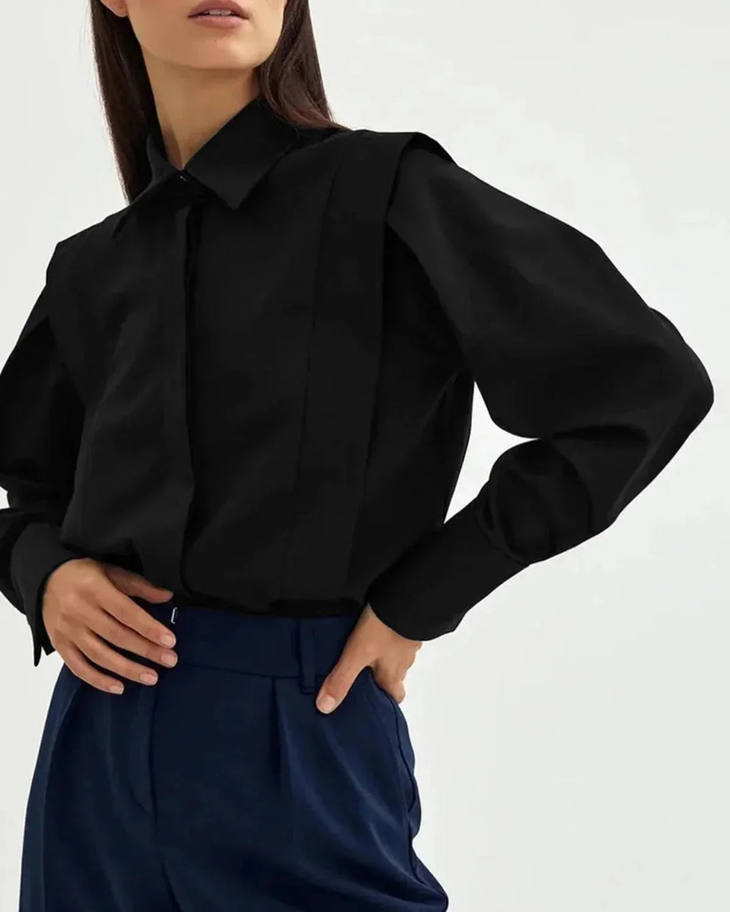 Detail of pointed collar and button placket on women's white structured shirt