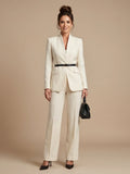 Women's tailored blazer in cream with stand collar and structured shoulders worn with matching trousers