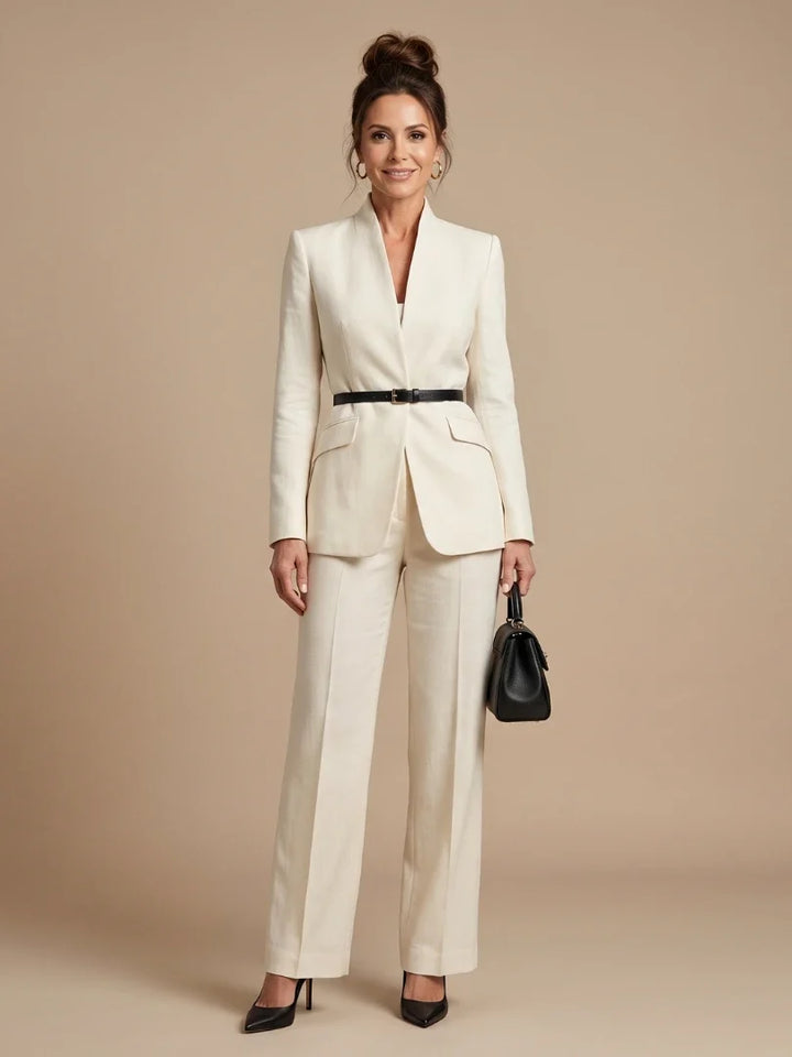 Women's tailored blazer in cream with stand collar and structured shoulders worn with matching trousers