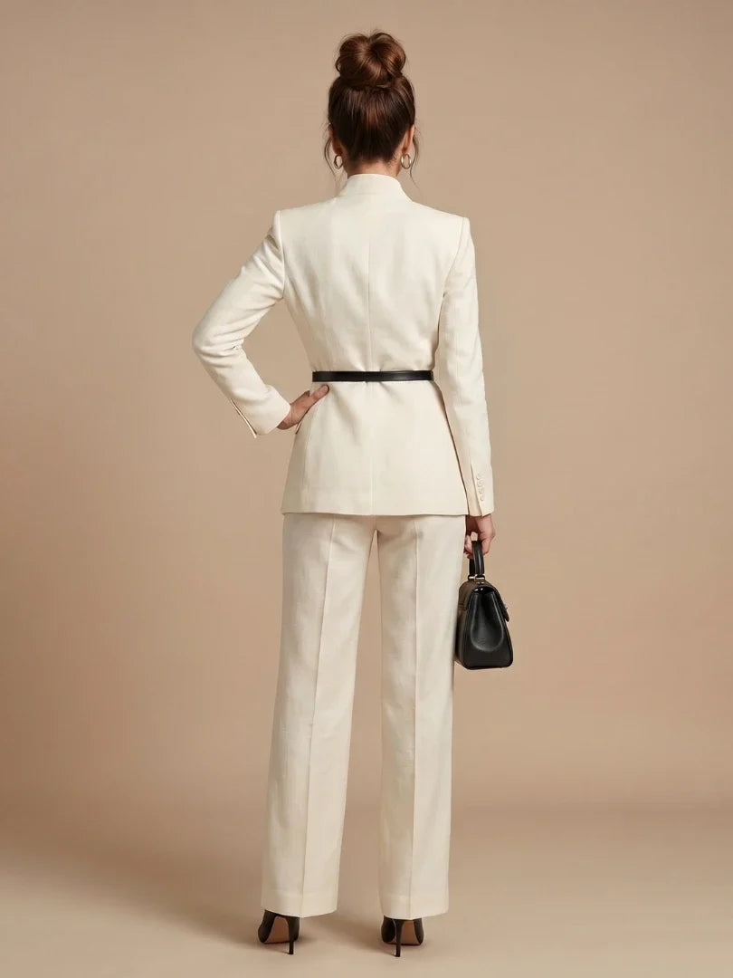 Women's cream blazer with stand collar styled with tailored trousers and black accessories