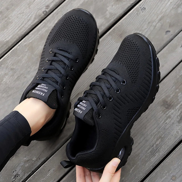 Close-up of men's trainers with textured knit mesh upper and lace-up closure
