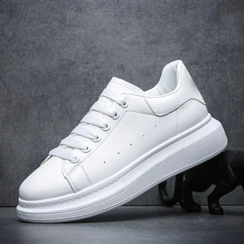 Men's chunky sole trainers in white with lace-up front and platform sole on dark background