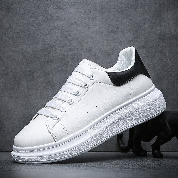 Side view of men's white chunky trainers showing perforated details and thick sculpted sole