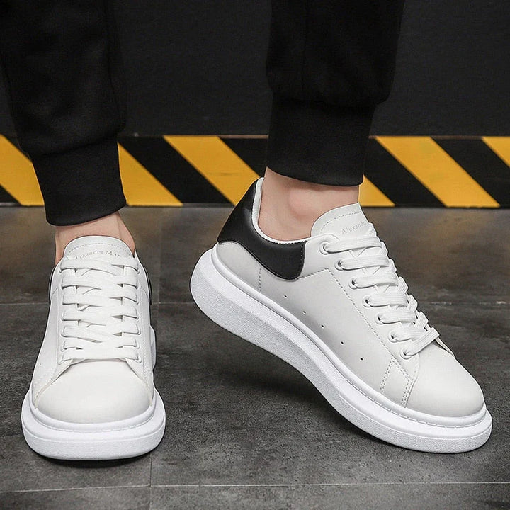 Close-up of men's platform trainers featuring smooth upper and padded collar construction