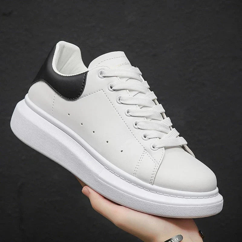 Full view of men's white chunky sole trainers with modern sculpted platform and smooth upper