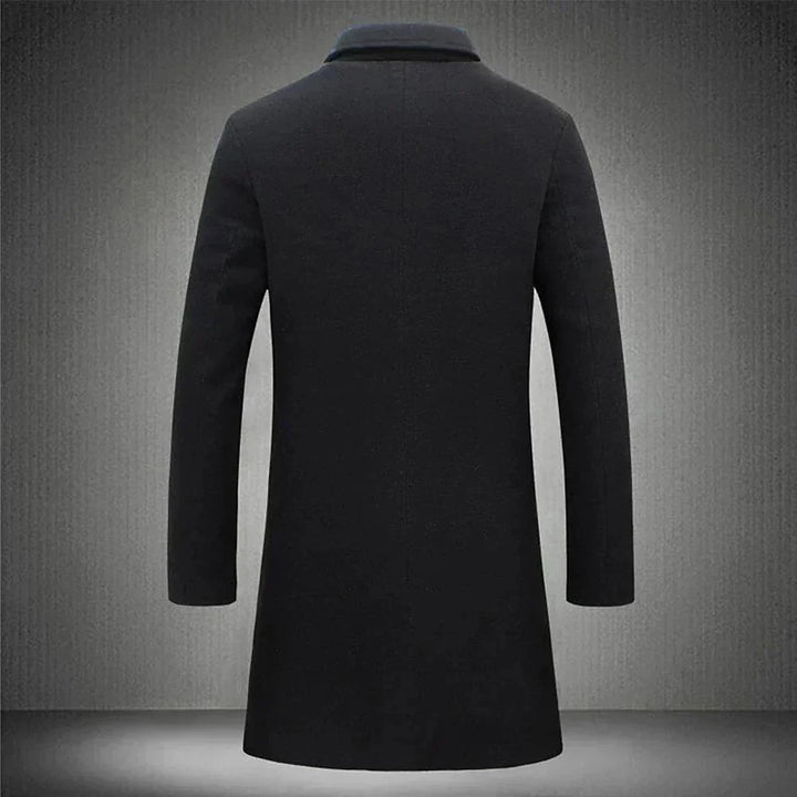 Side profile of men's knee-length overcoat displaying relaxed fit and tailored silhouette