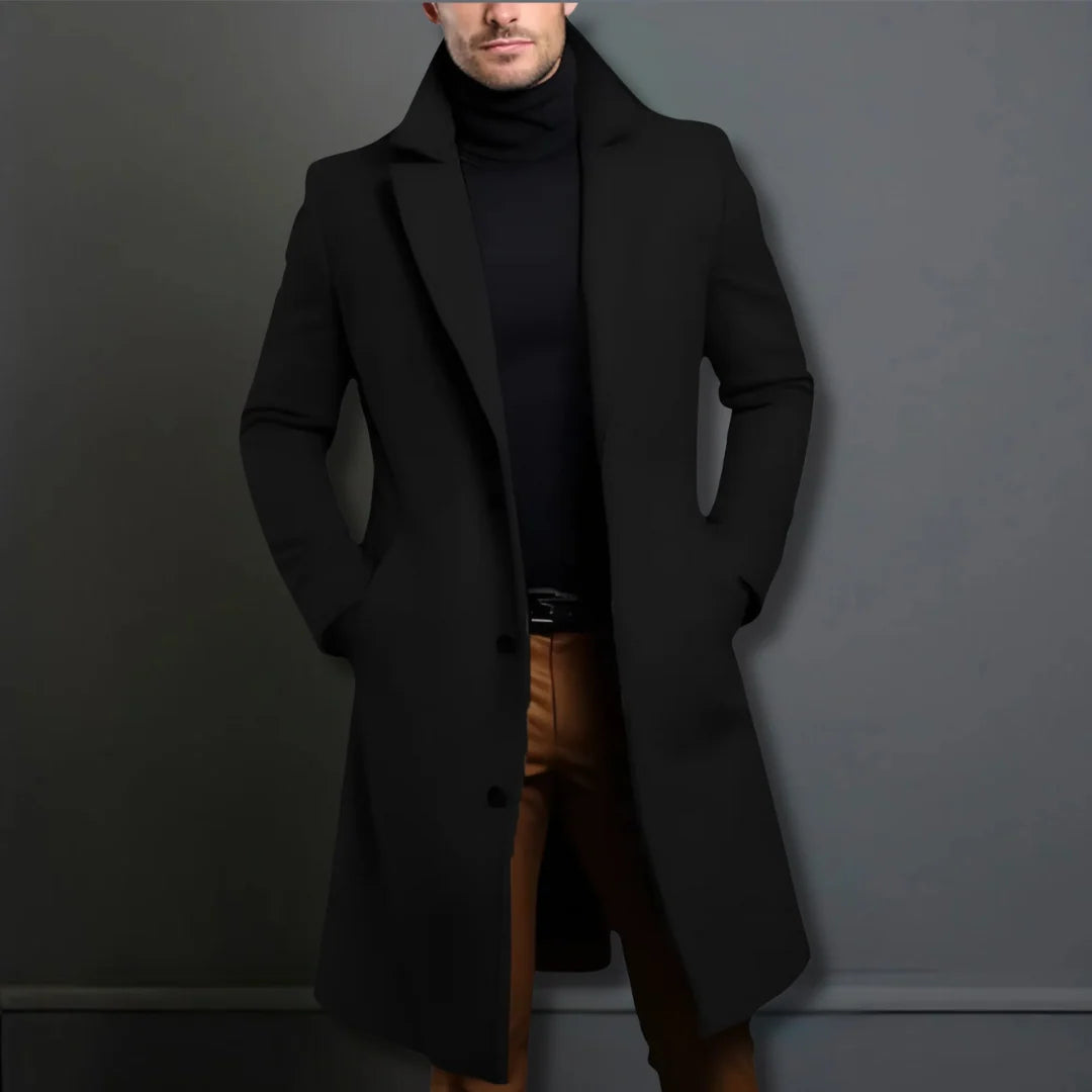Men's tailored overcoat worn over formal trousers showing knee-length cut