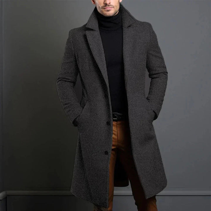 Close-up of men's overcoat button-front closure and welt pocket detailing