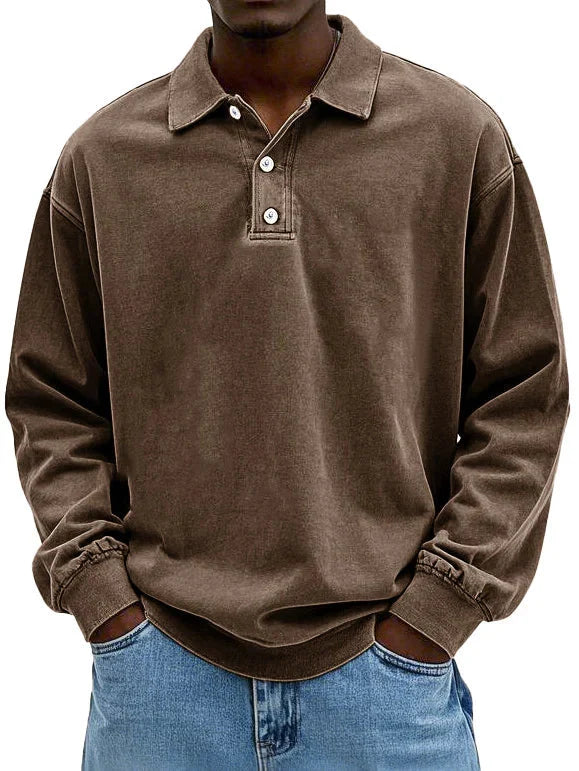 Detail of ribbed cuffs on men's long sleeve polo shirt in blue