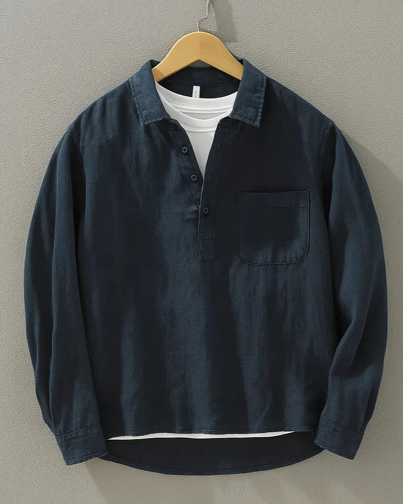 Men's navy popover shirt with half-button placket and chest pocket, displayed on hanger
