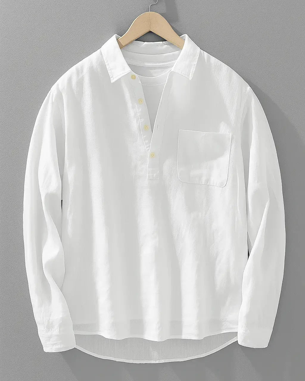 Close-up view of men's long sleeve popover shirt showing textured fabric and button detail