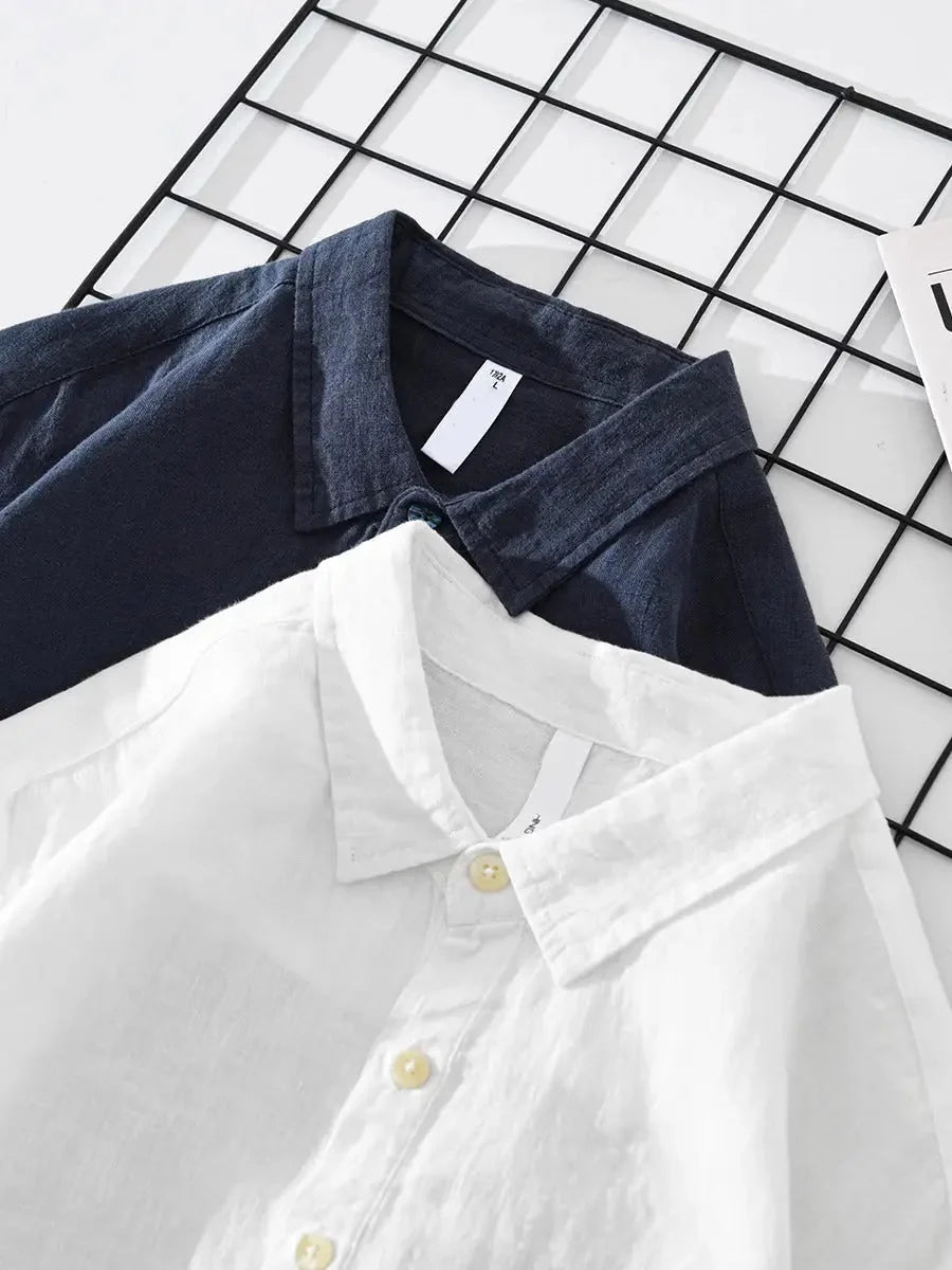 Men's long sleeve popover shirt styled over white tee showing relaxed fit and drape