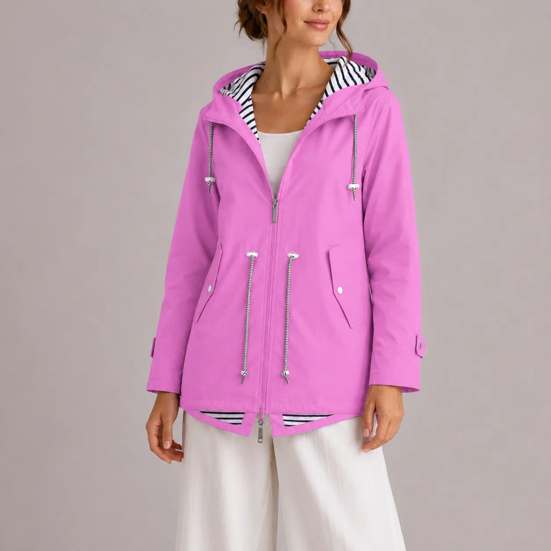 Women's hooded raincoat with zip-front closure and striped lining detail, shown in orchid pink