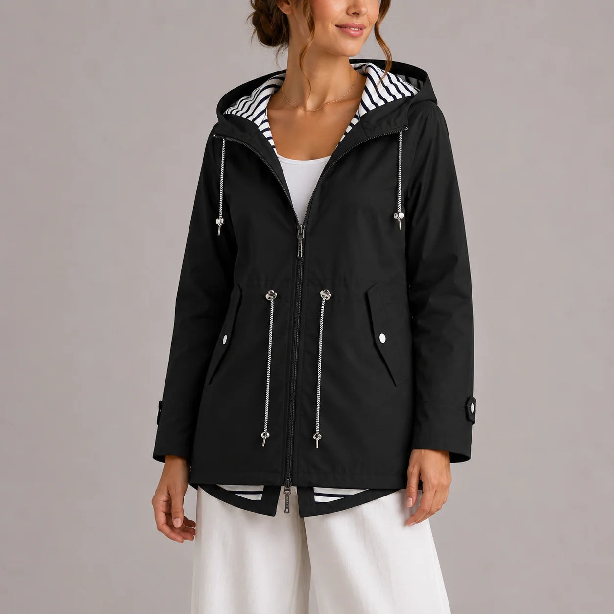 Side view of women's hooded raincoat showing relaxed fit and practical pockets