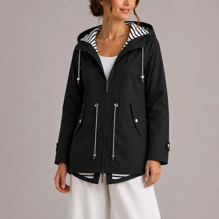 Side view of women's hooded raincoat showing relaxed fit and practical pockets