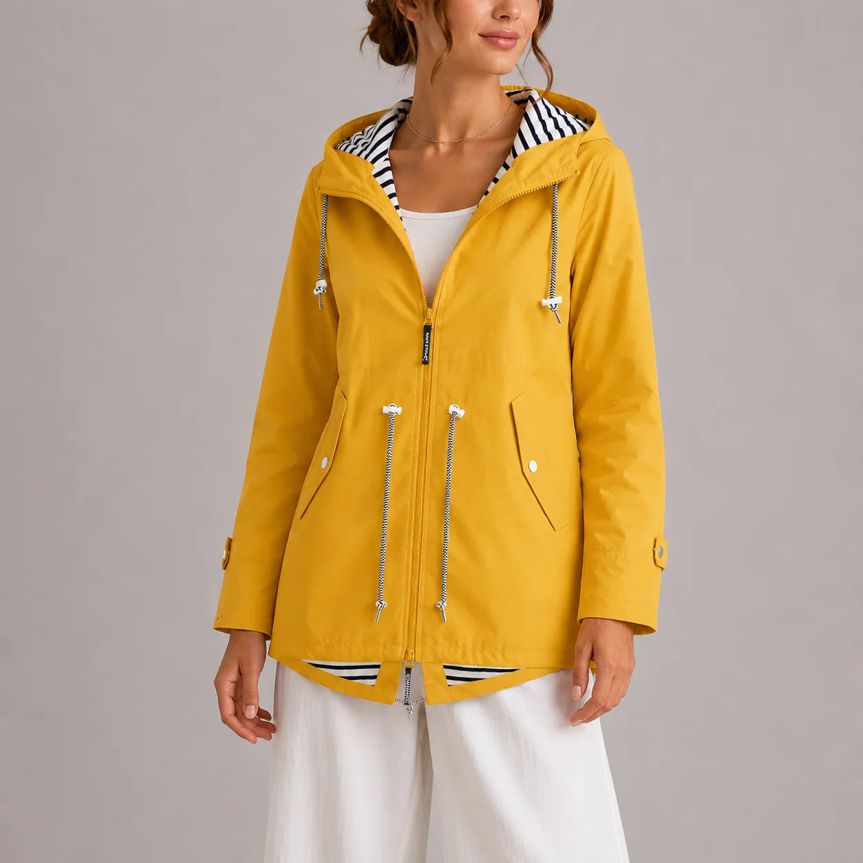 Back view of women's hooded raincoat showing relaxed silhouette and hood detail