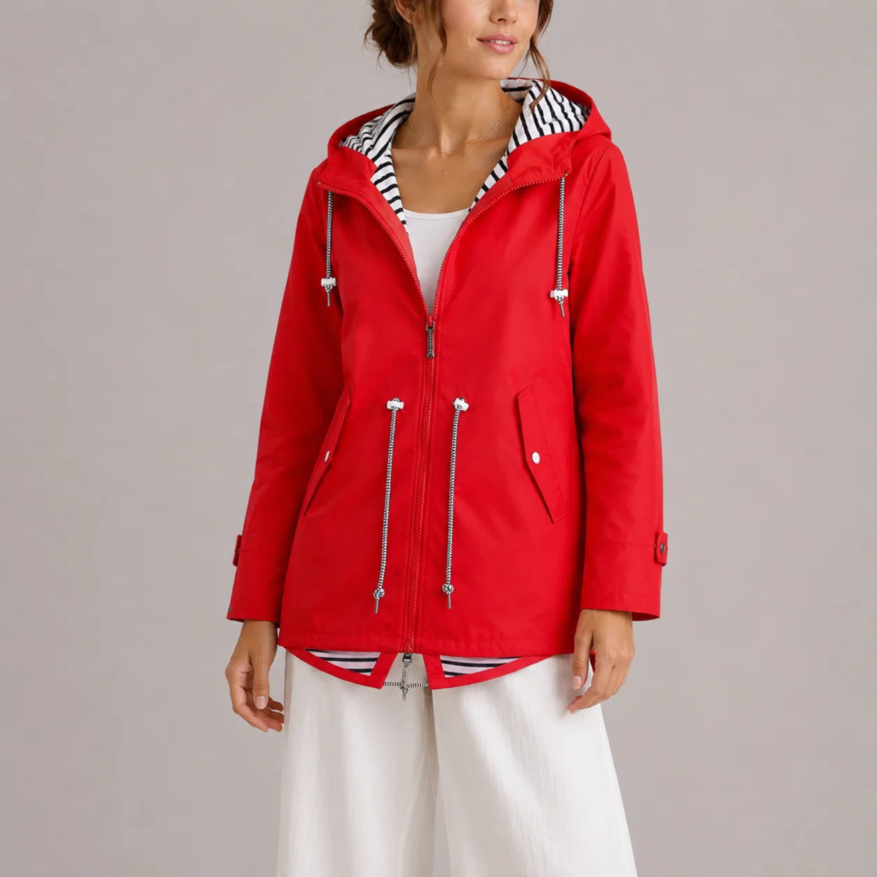Women's hooded raincoat with adjustable waist drawstring and front pocket detail