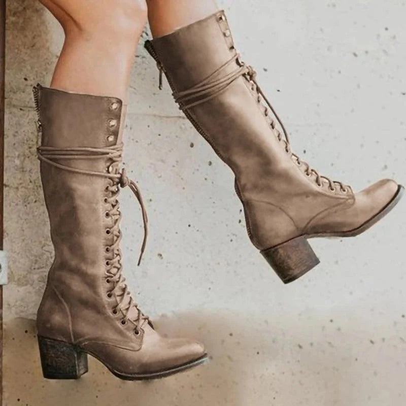 Full-length view of women's knee-high boots paired with casual autumn styling