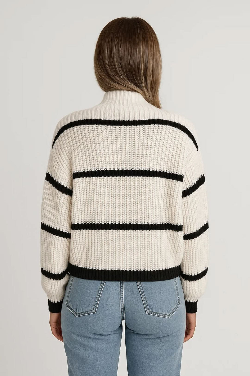 Detail of striped turtleneck jumper sleeve showing ribbed texture and contrasting black cuffs