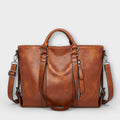 Women's structured tote bag in tan with dual handles and adjustable shoulder strap