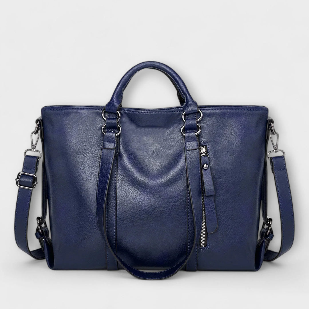 Detail shot of tote bag hardware and smooth finish material texture