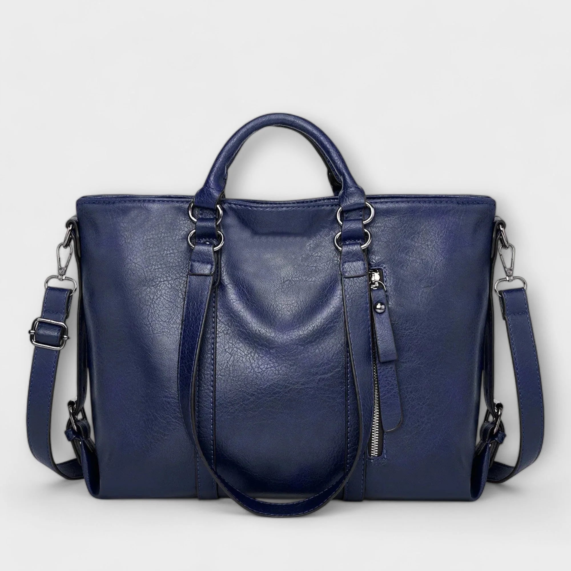 Detail shot of tote bag hardware and smooth finish material texture