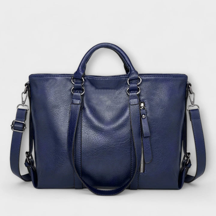 Detail shot of tote bag hardware and smooth finish material texture