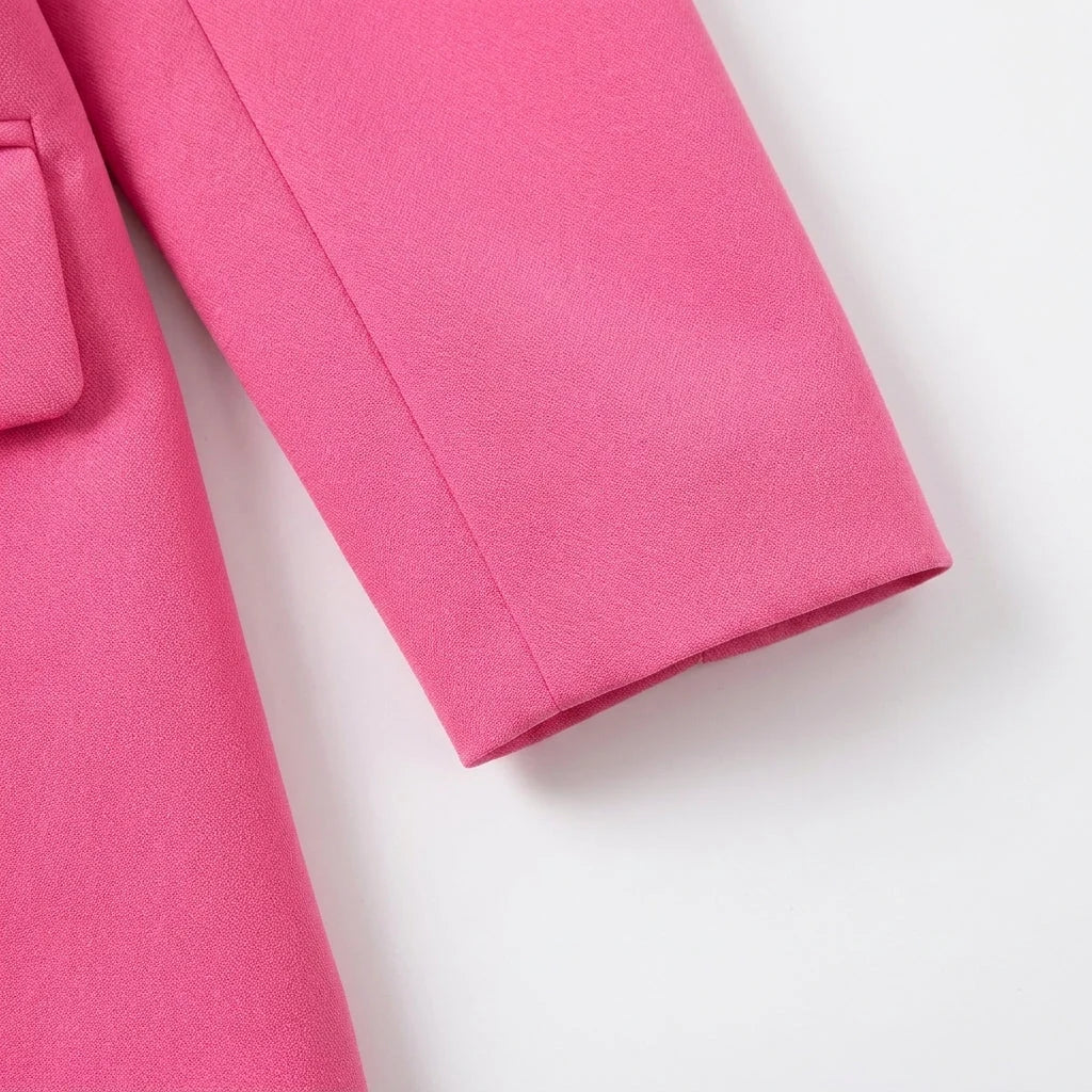 Back view of women's tailored blazer showing structured shoulders and centre vent detail