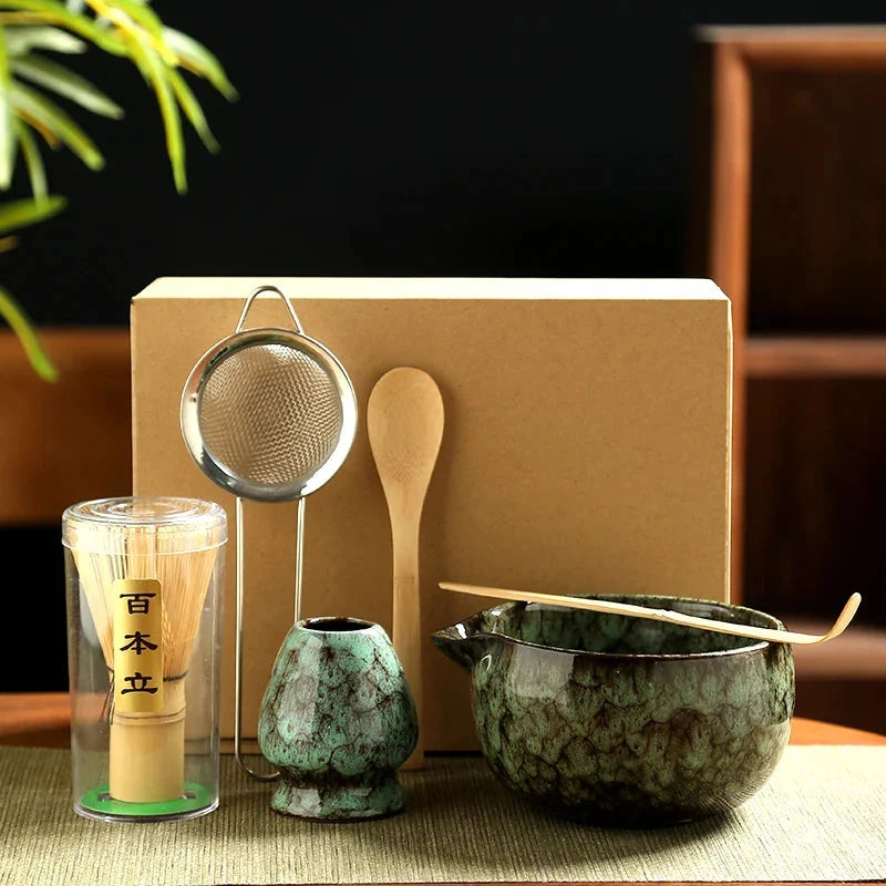 Matcha tea set showing ceramic bowl with pouring spout and bamboo whisk holder in blue glaze