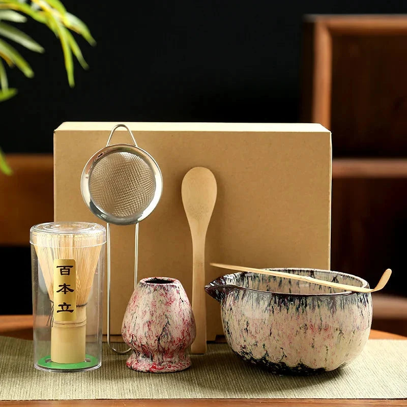 Traditional matcha tea bowl with reactive blue glaze and natural bamboo tools