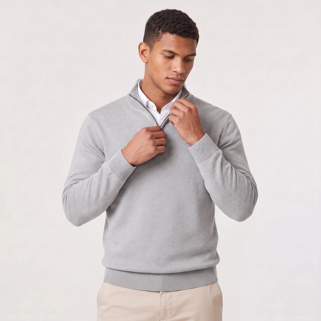 Men's dark grey quarter-zip knit jumper styled with chinos for business-casual wear