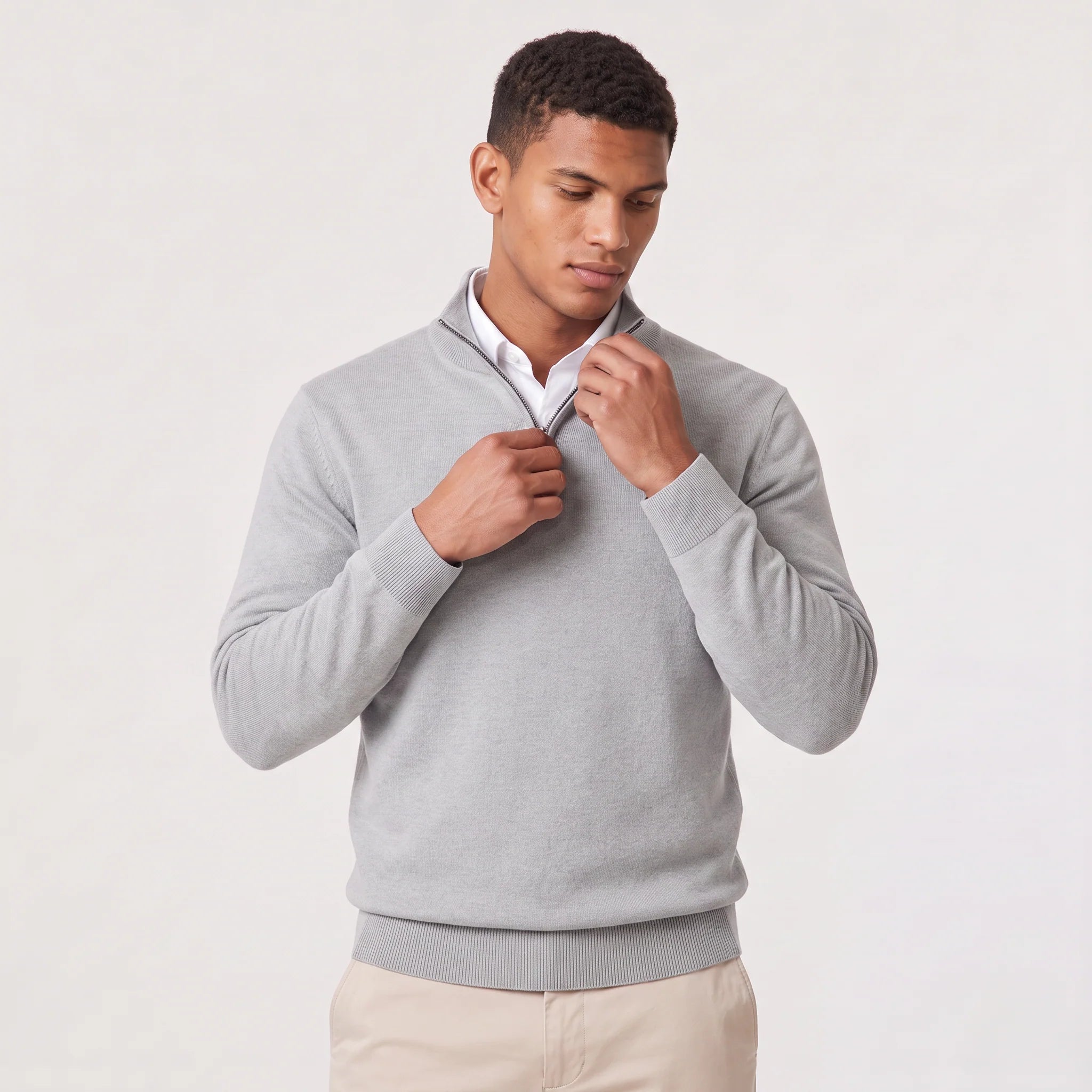 Men's dark grey quarter-zip knit jumper styled with chinos for business-casual wear