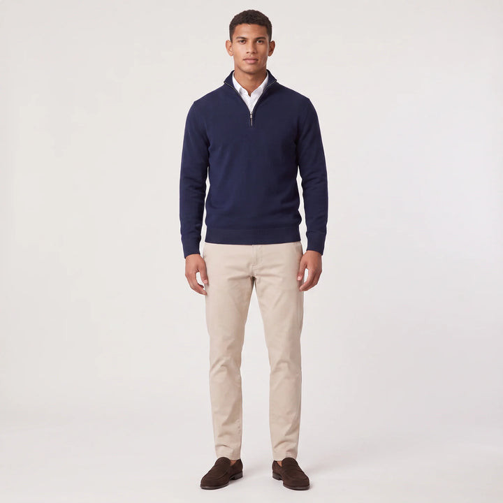 Detail of quarter-zip closure on men's knit jumper with contrast trim at neckline