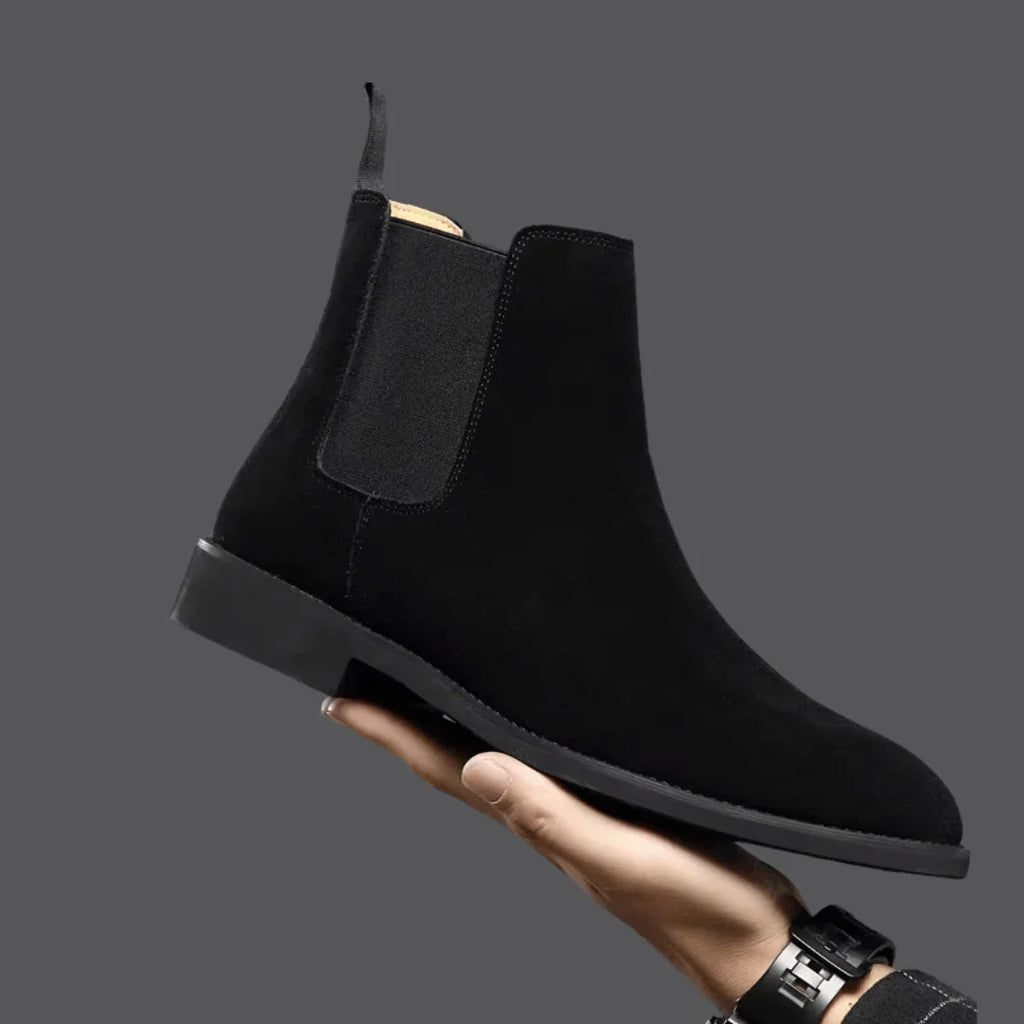 Side view of men's Chelsea boots showing slip-on design and pull tab detail