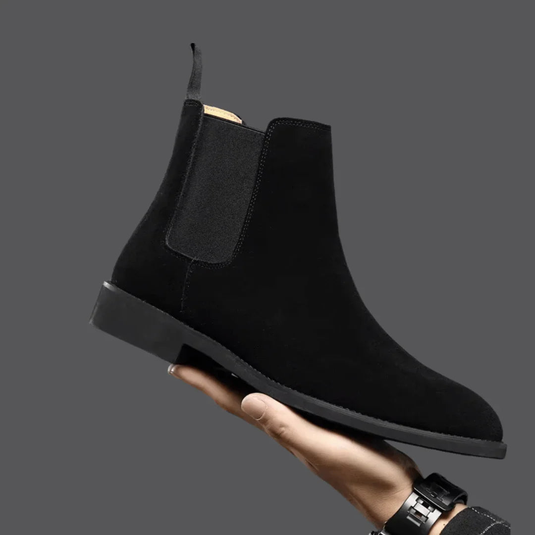 Side view of men's Chelsea boots showing slip-on design and pull tab detail