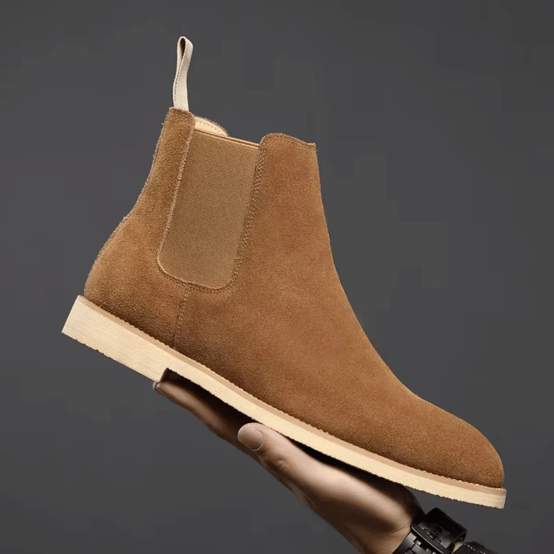 Close-up of elasticated side panel and stitched welt on men's Chelsea boots