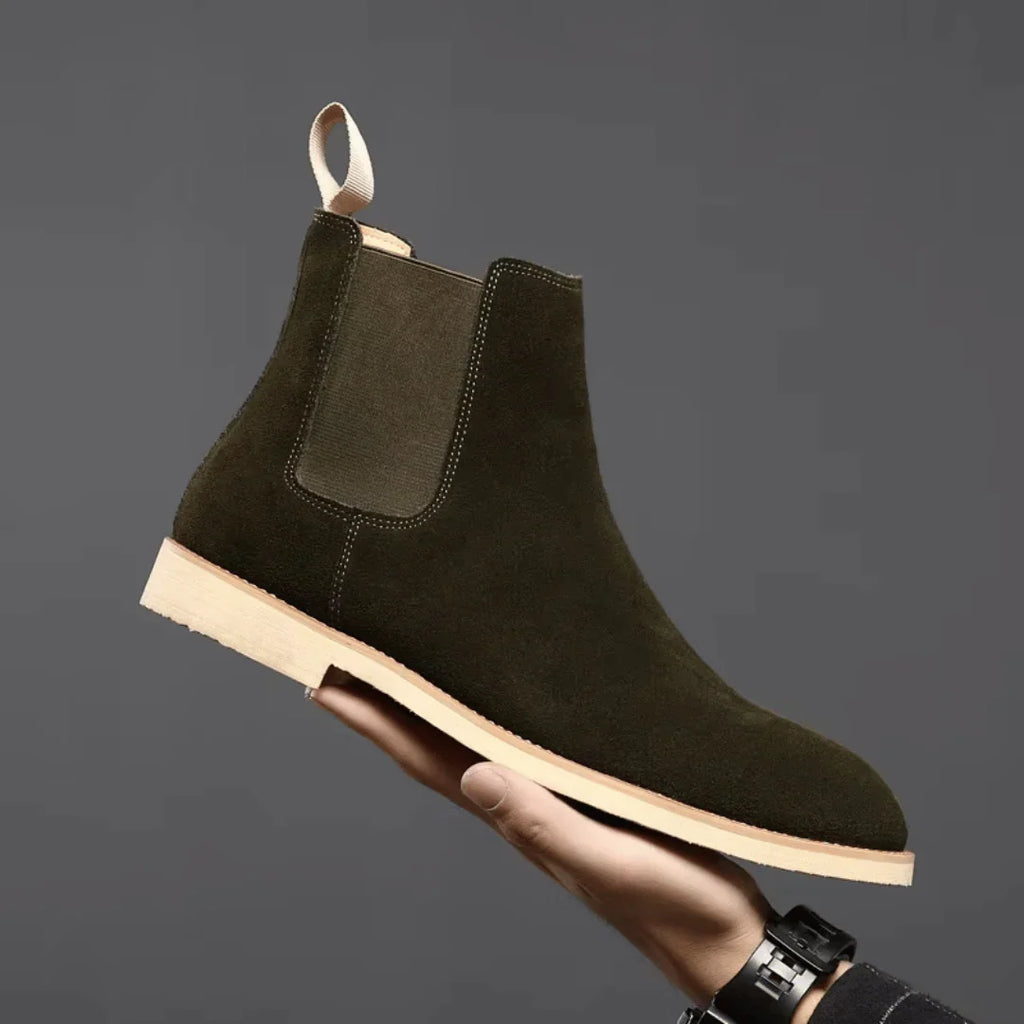 Men's Chelsea boots displayed from above showing textured upper and smooth sole