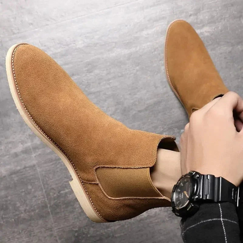Men's Chelsea boots in beige showing ankle height and classic silhouette