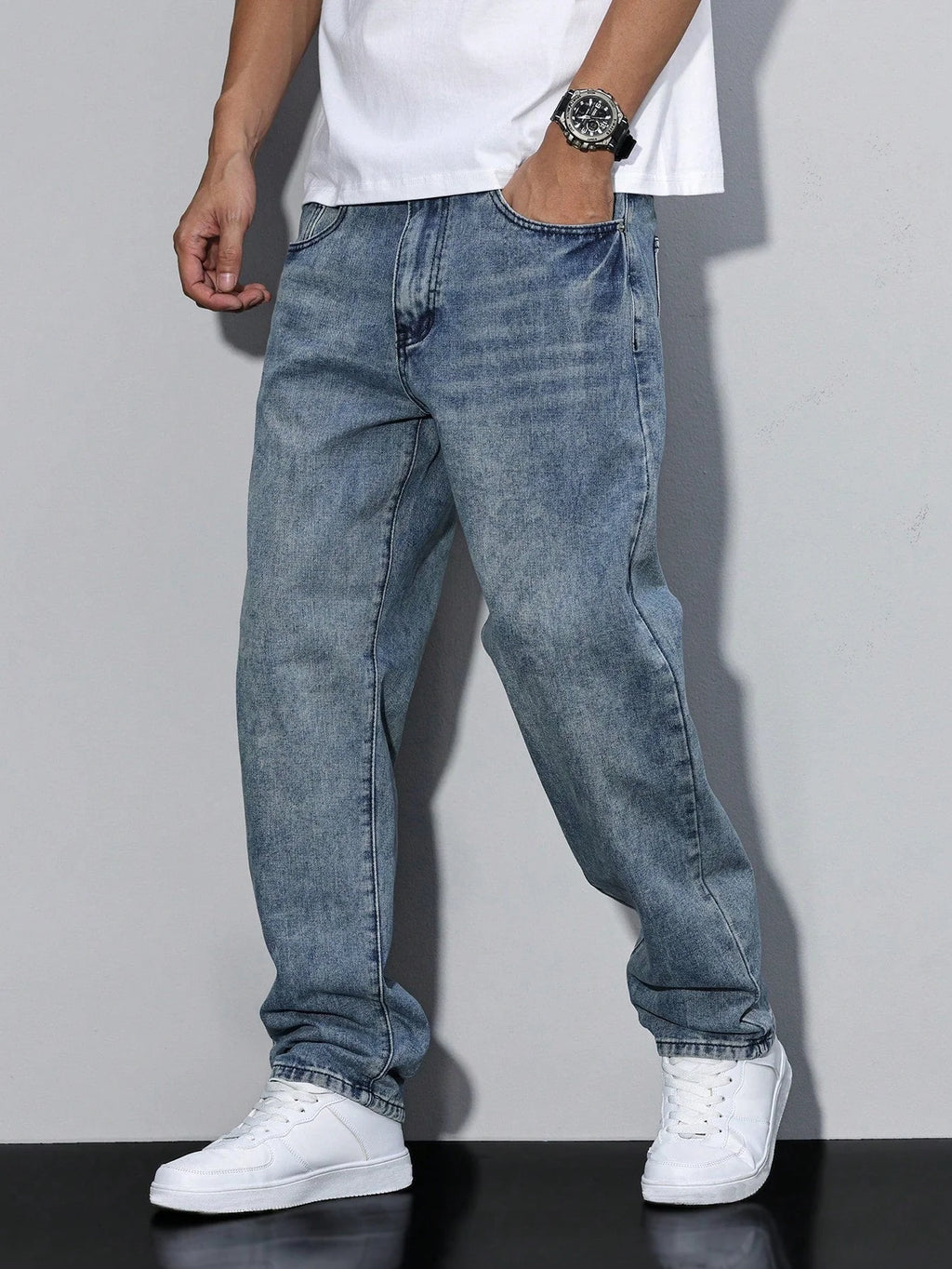 Close-up of men's jeans waistband with button closure and belt loops