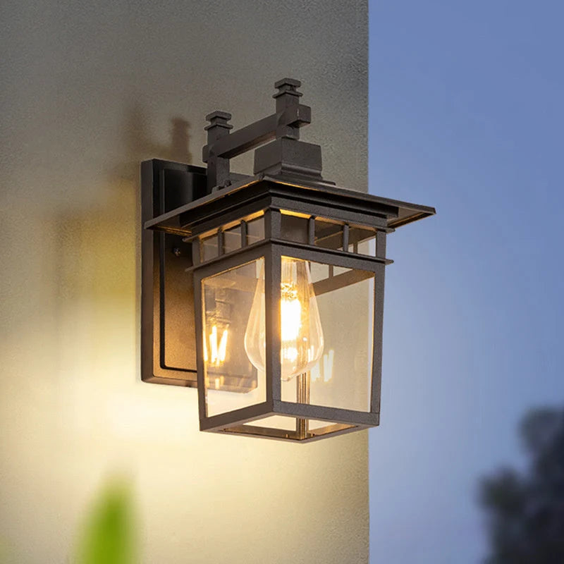 Outdoor lantern wall light with aluminium frame and clear glass mounted on exterior wall