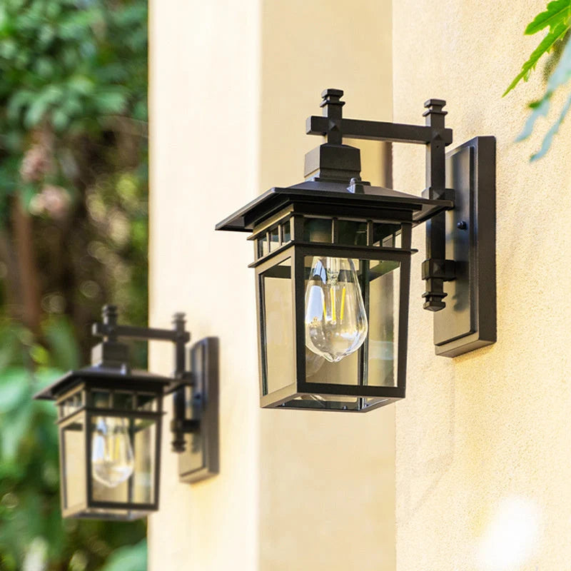 Front view of outdoor lantern wall light with clear glass and visible bulb fitting