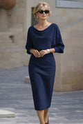Navy blue cowl neck midi dress with batwing sleeves and ribbed knit fabric shown on model