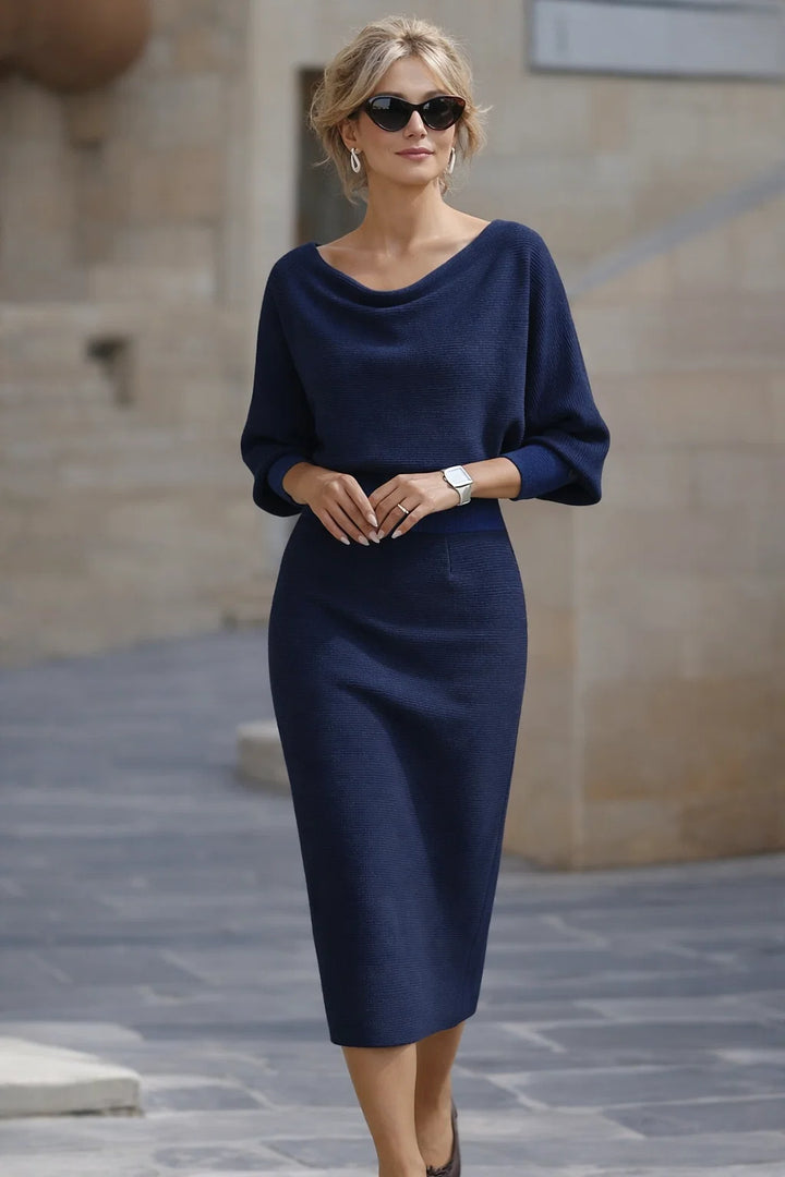 Navy blue cowl neck midi dress with batwing sleeves and ribbed knit fabric shown on model