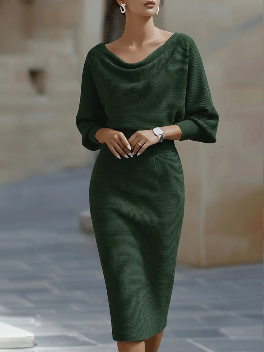 Navy blue ribbed midi dress with cowl neck shown in natural outdoor setting