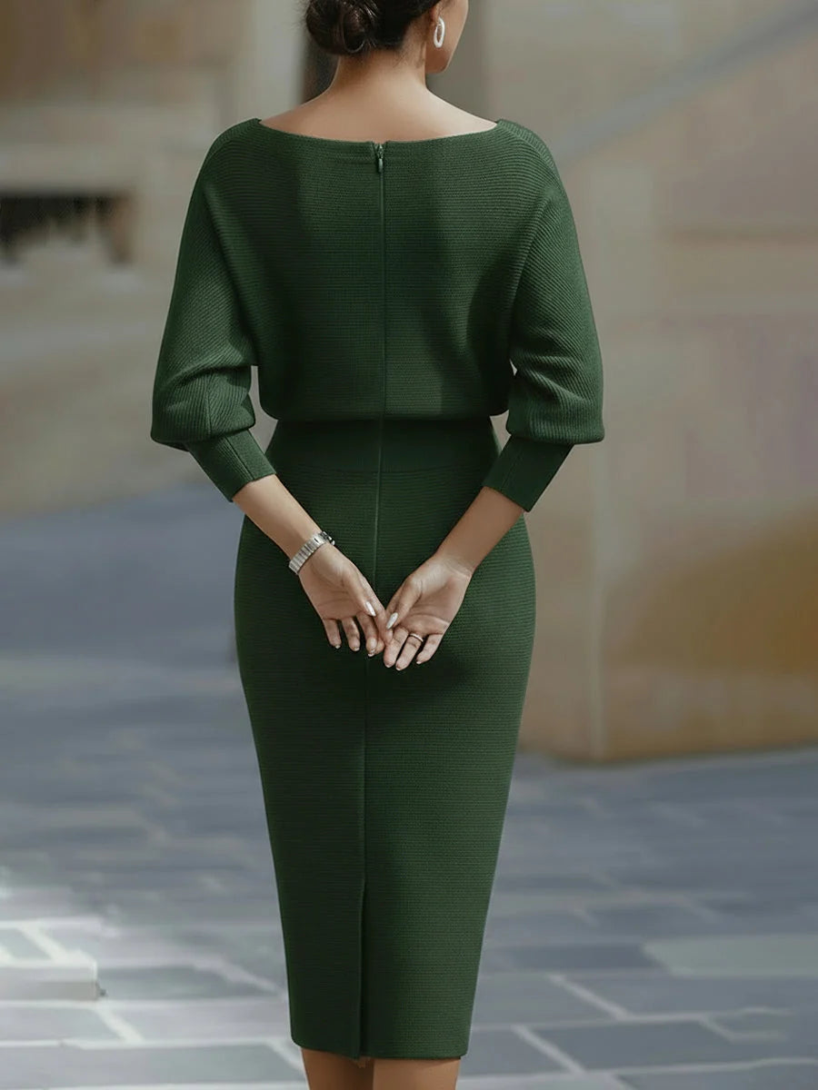 Close-up of cowl neck draping and batwing sleeve construction on midi dress