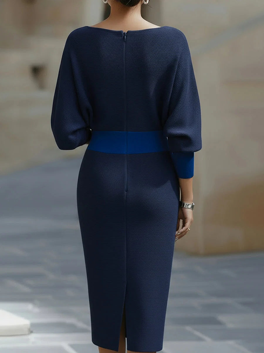 Model styled in navy cowl neck midi dress for smart-casual autumn occasion