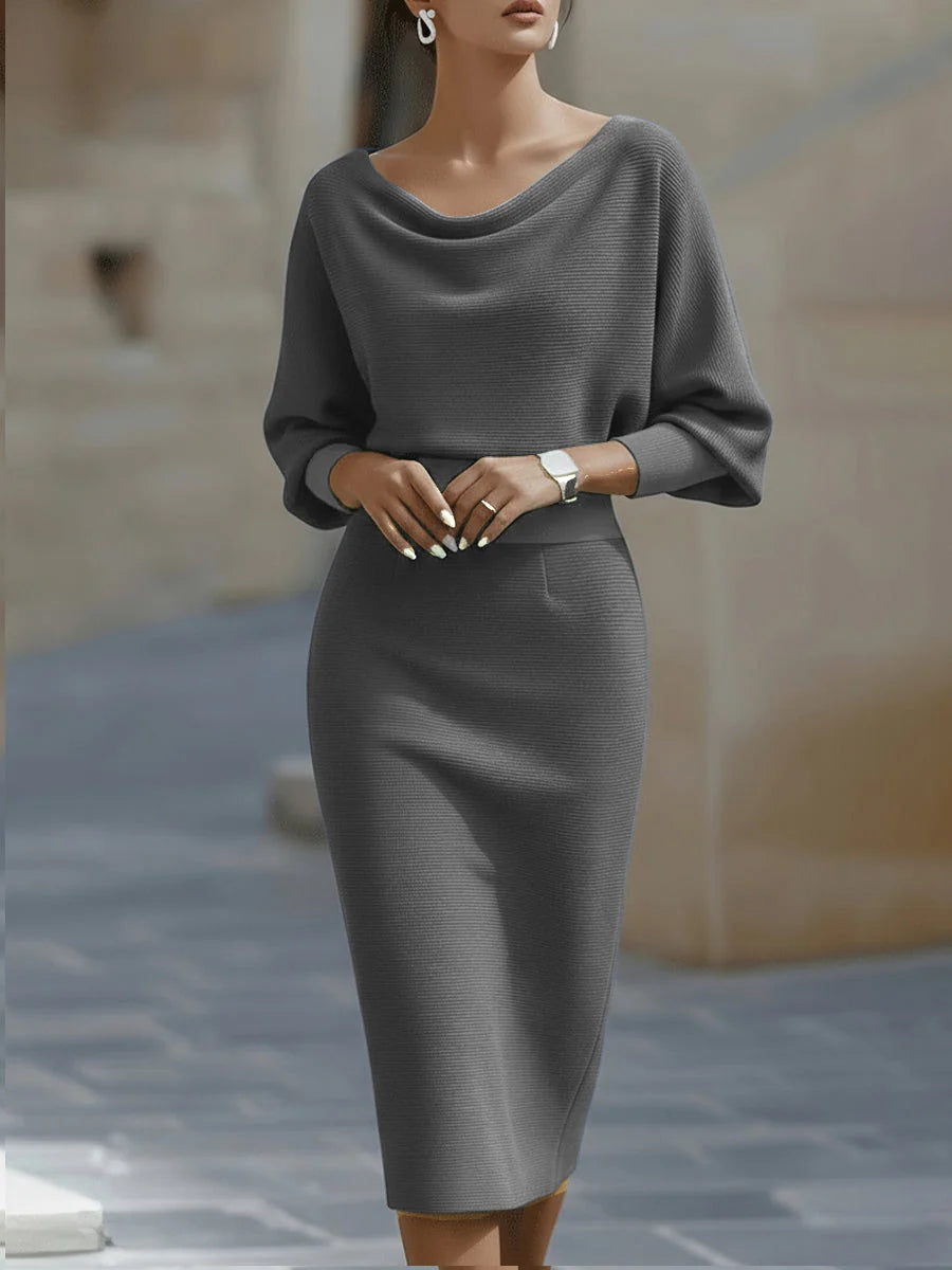 Detail view of ribbed knit texture and draped neckline on navy midi dress