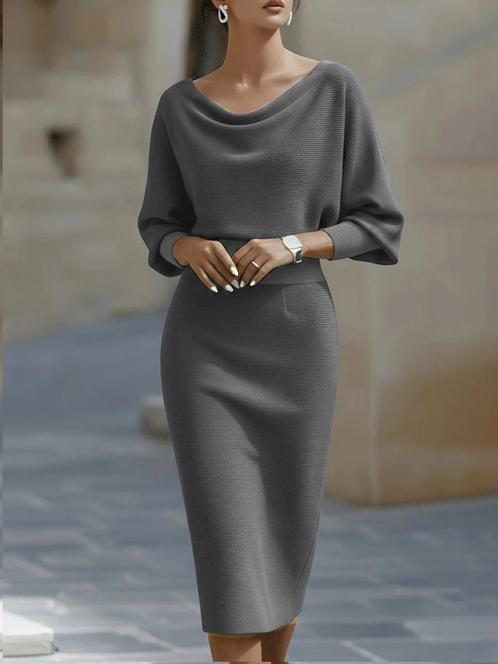 Detail view of ribbed knit texture and draped neckline on navy midi dress