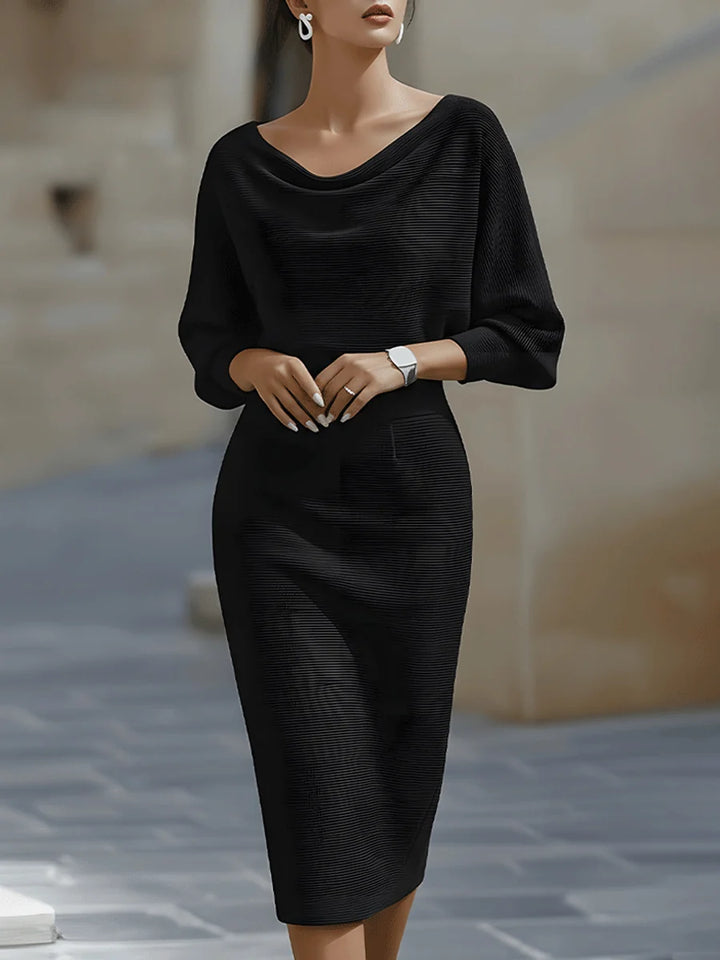 Close-up view of draped cowl neckline on navy ribbed midi dress with three-quarter sleeves